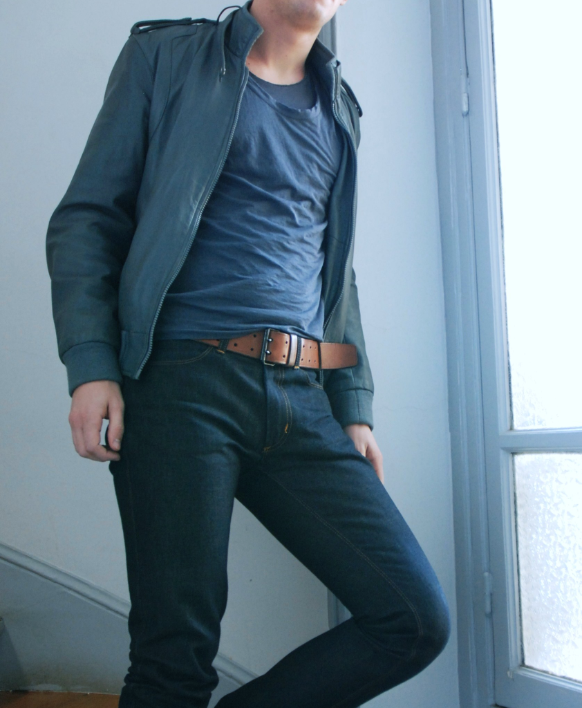 man wearing blue jacket, round neck shirt and jeans with leather brown belt