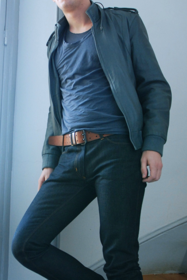 man wearing blue jacket, round neck shirt and jeans with leather brown belt